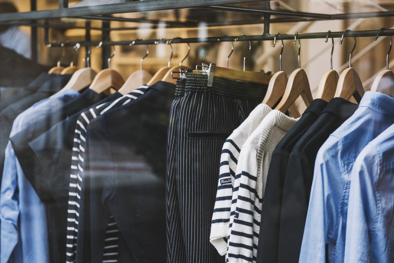 shirts and pants on hangers hanging on a rack illustrating ecommerce fulfillment services