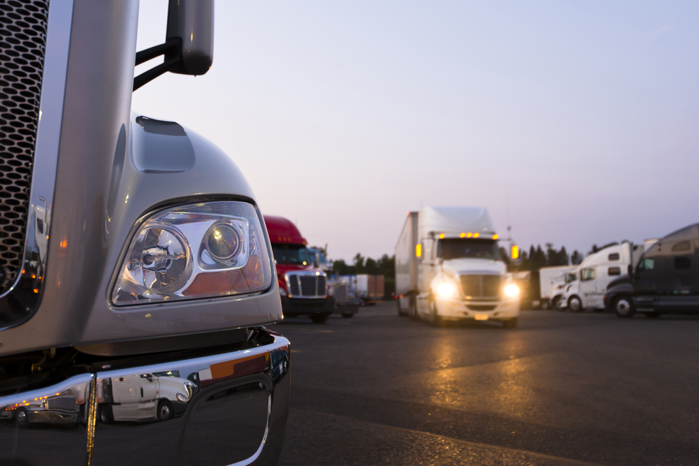 several big rig trucks leaving a 3pl fulfillment center