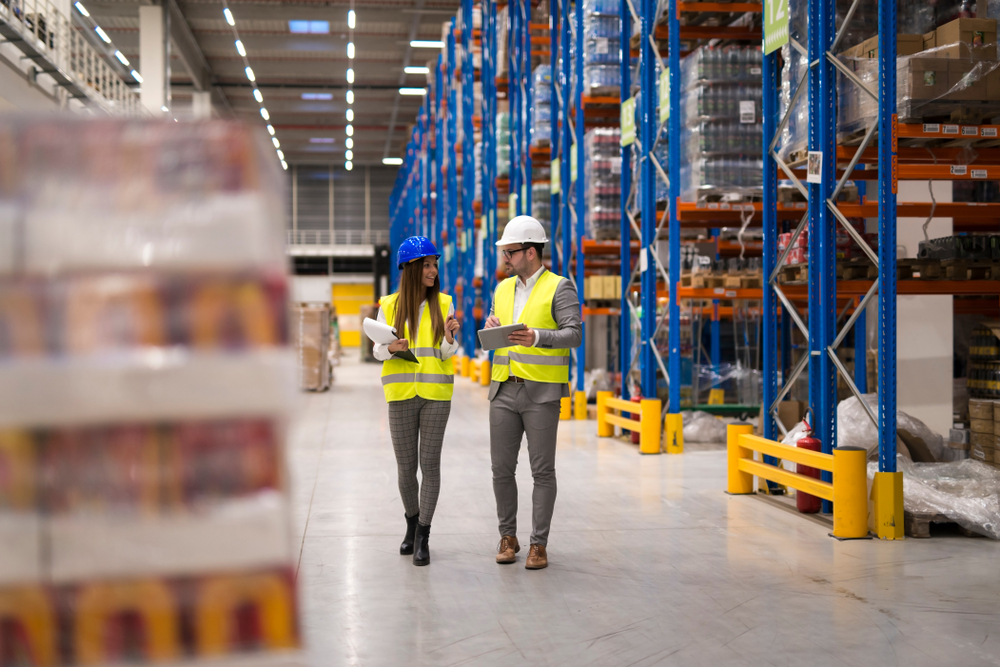 two associates walking through a warehouse of a shipping and logistics company