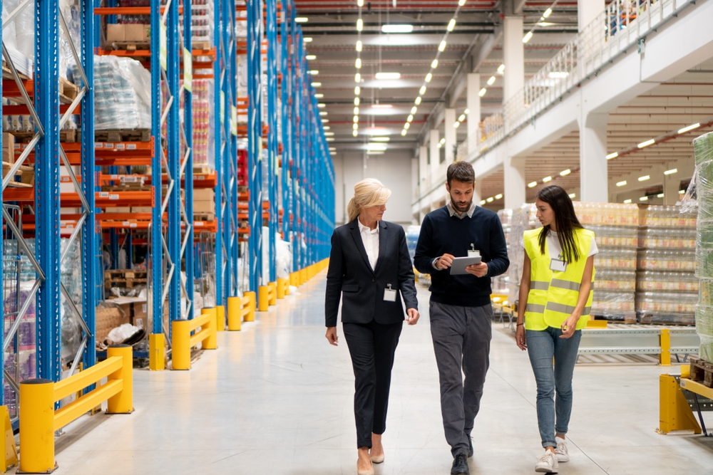 three employees walking through a warehouse discussing 3pl ecommerce fulfillment